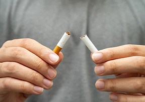 Closeup of patient breaking cigarette