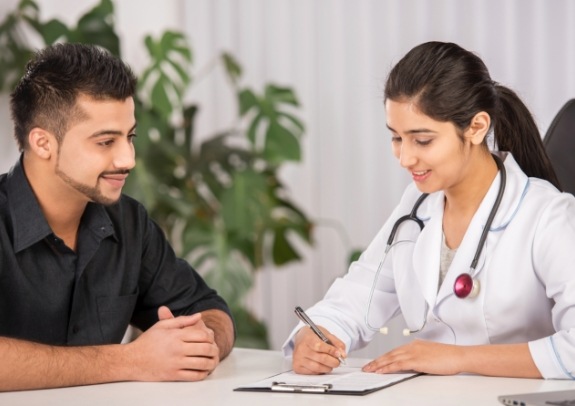 Dental team member and patient in consultation room