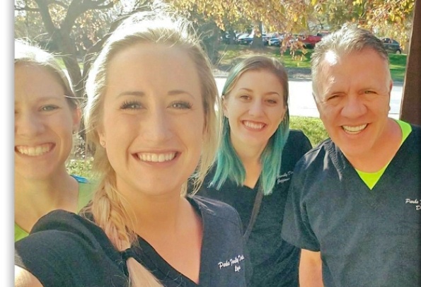 Friendly Lincoln Nebraska dental team smiling together outdoors