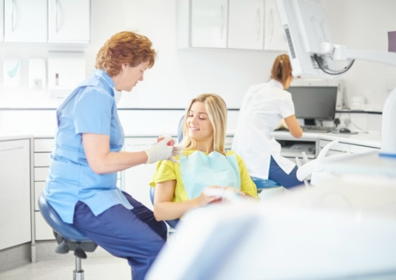 Dental team member and patient discussing how clearcorrect works