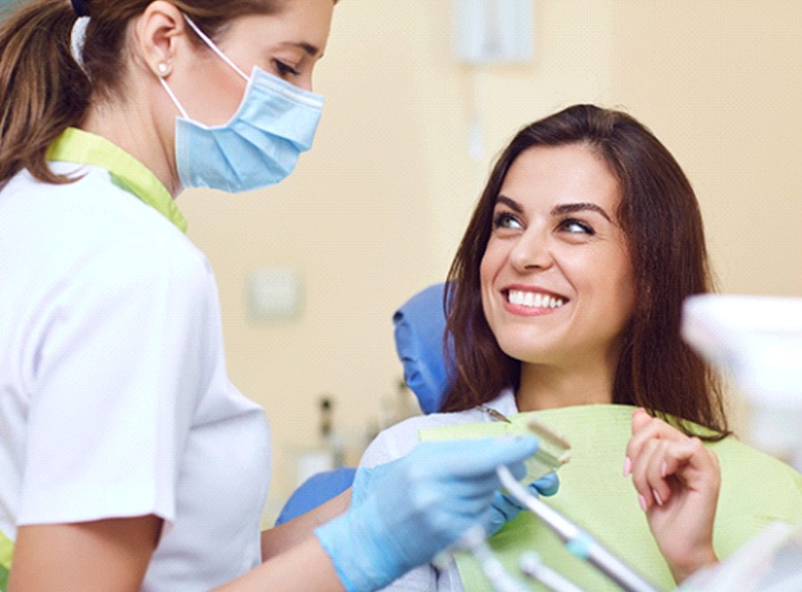 Dentist in Lincoln assisting a smiling patient