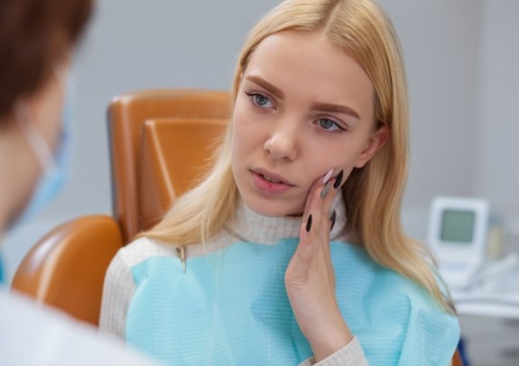 Woman discussing the cost of emergency dentistry with dentist