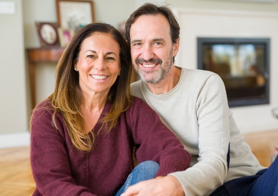 Smiling couple enjoying the benefits of dental implants