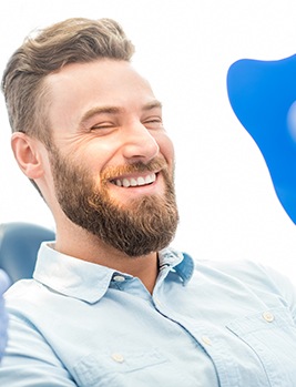 Man laughing with dentist at the dental office