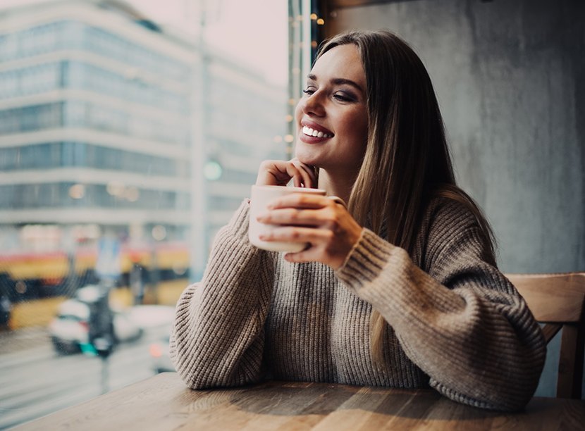 Woman holding mug smiling