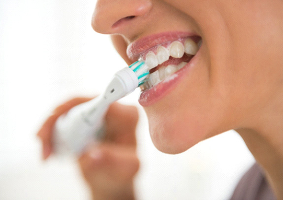 closeup of person brushing teeth 