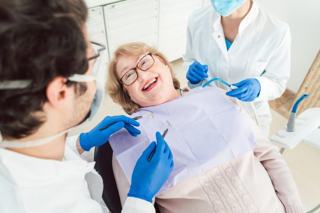 Smiling patient listening to dentist talk about gum disease