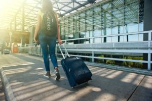 Woman pulling suitcase through airport