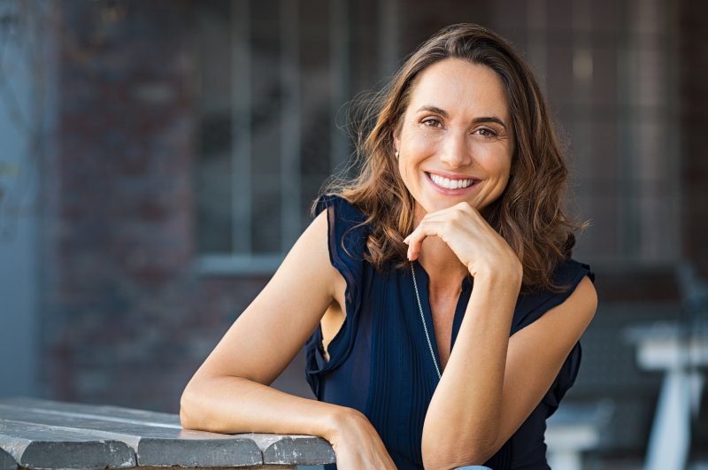 a woman smiling with bright teeth after undergoing cosmetic dentistry