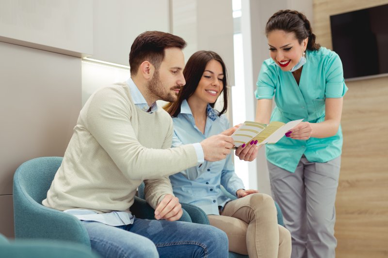 A dentist explaining dental insurance to her patients