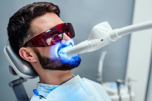 Bearded male patient having teeth professionally whitened in-office